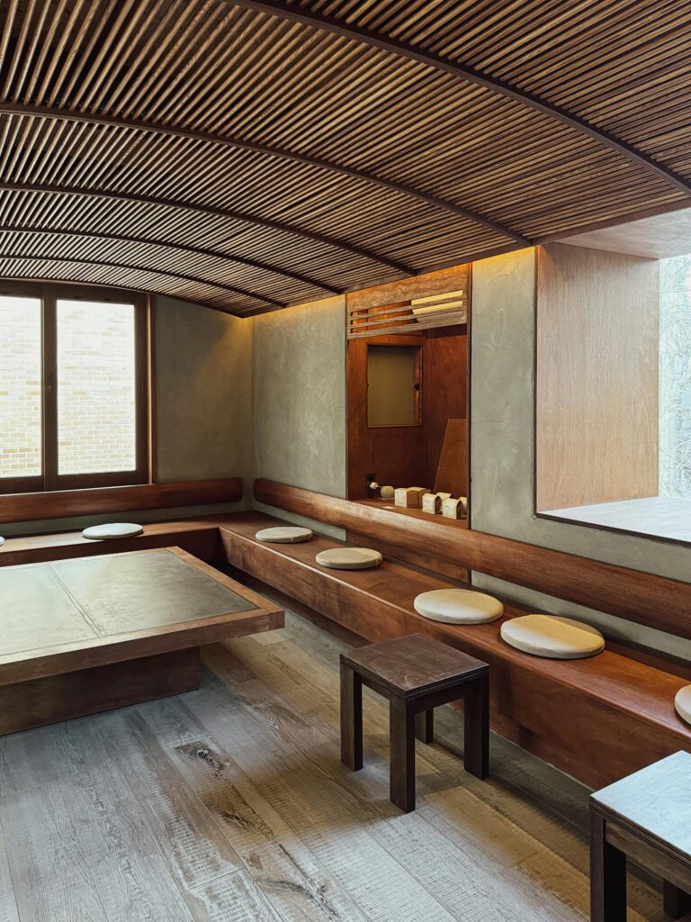 Contemporary minimalist room with wooden decor and seating. Ideal for relaxation and meetings.