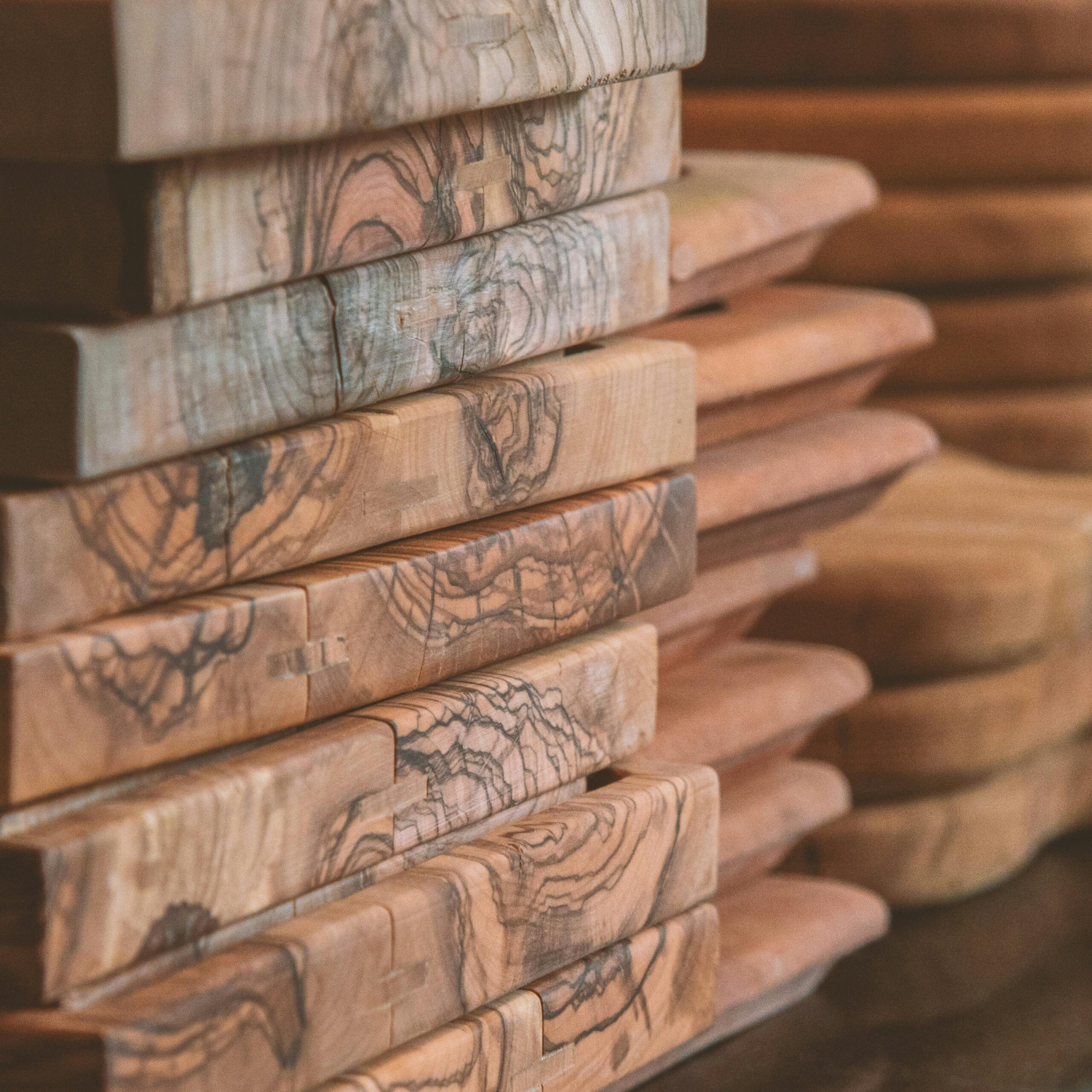 Close-up view of stacked wooden cutting boards with grain detail, Riyadh.